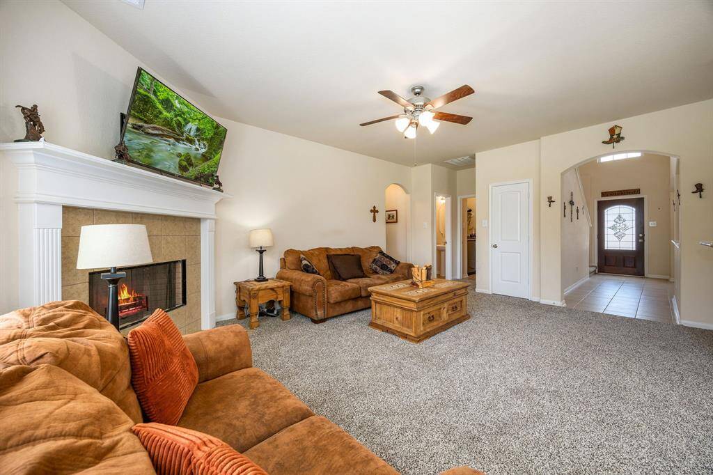 Family room with a cozy corner gas fireplace and BRAND new carpet.