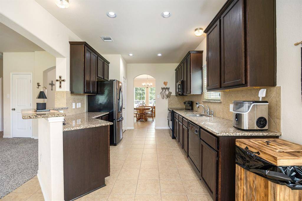 Open kitchen area with tons of storage cabinets and granite countertops