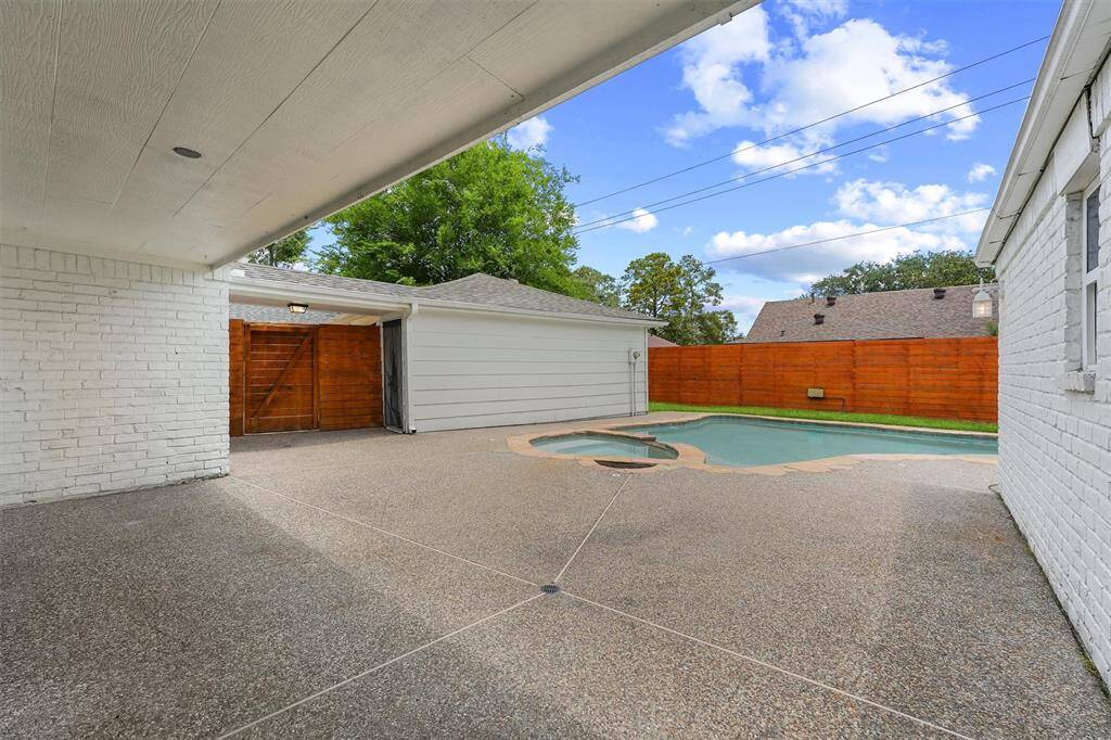 Covered patio for al fresco dining and living.  Enjoy your heated hot tub and pool year round!