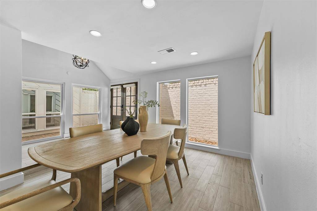 View of the dining room and to the left is a small courtyard patio.  Perfect spot for a lounge set to enjoy a beverage.