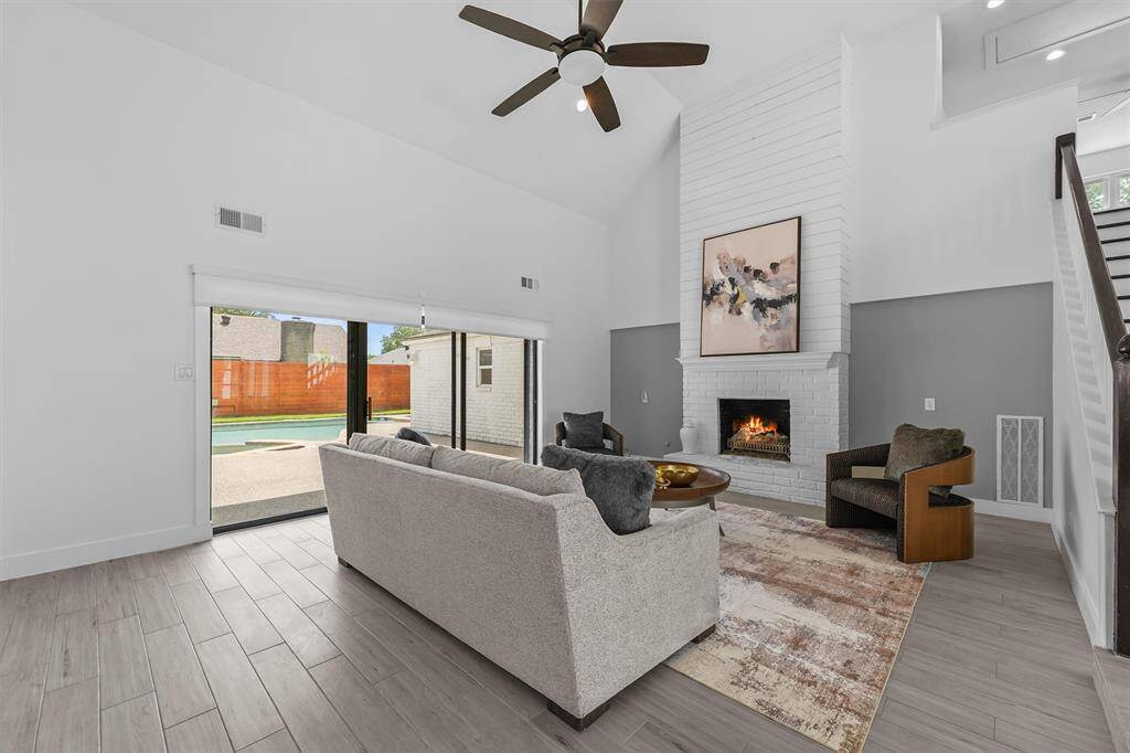 Wow!  Brick/wood fireplace, soaring ceiling, view to your pool and plenty of space for large couches and chairs.