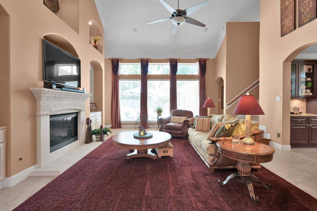 Living Room has Gas Fireplace and Stately Built-In Cabinetry.