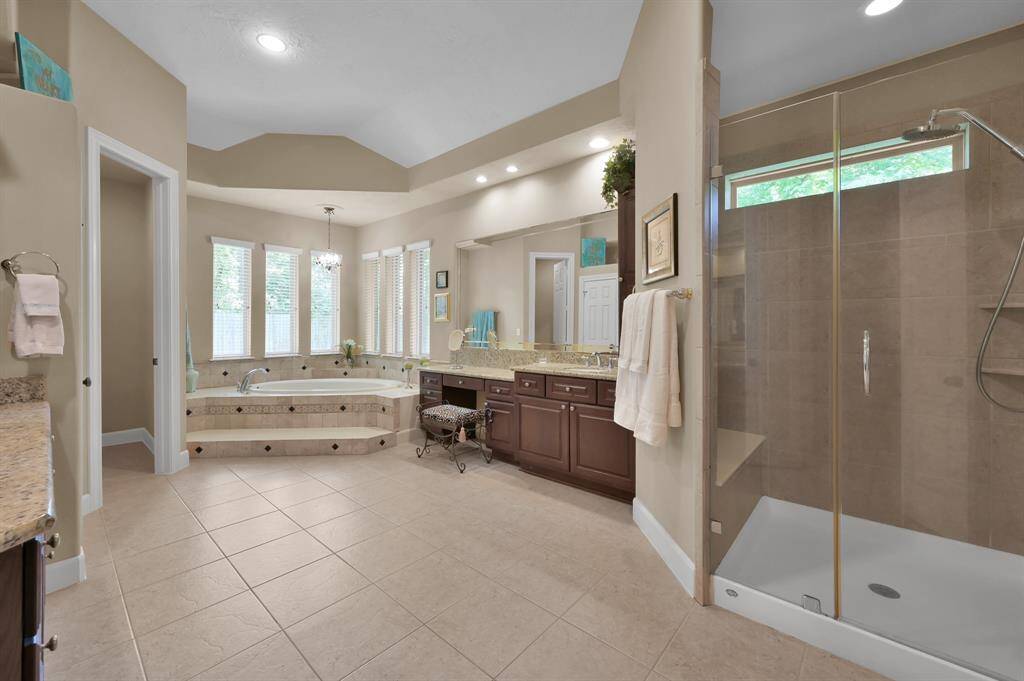 Large Shower and Spa Tub Separate Vanities Create a Spa Like Atmosphere.