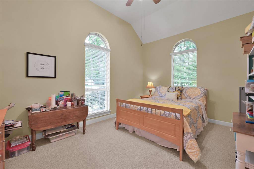 Coffered Ceiling and Well Placed Windows Allow for a Bright and Cheerful Secondary Bedroom and Craft Space.