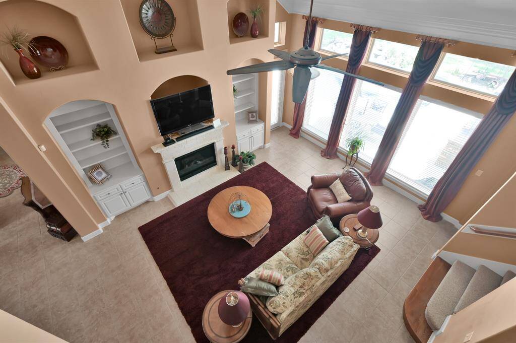 Balcony From Media Room Open to Living Room and Shows Staircase.