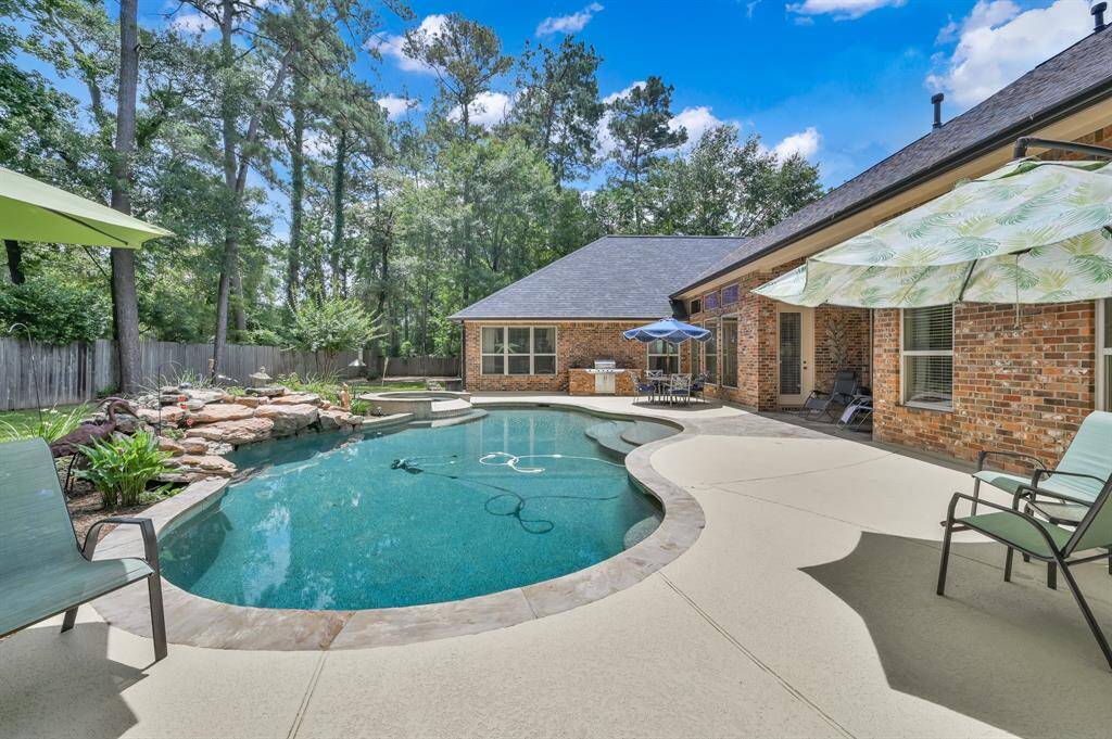 Saltwater Pool Surrounded by Decking, Rock Waterfall and Mature Trees.