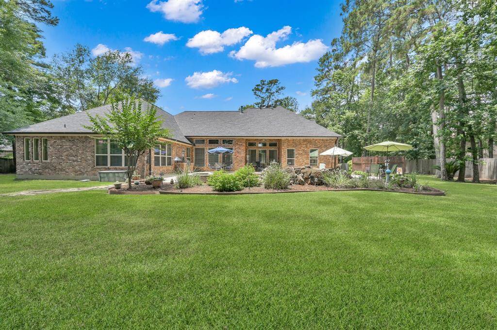 Beautiful Landscaping and Lush Lawn in Backyard.