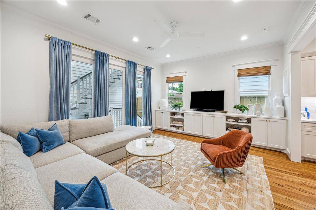 The family room sits at the back of the home and features lovely built-ins and floor to ceiling windows