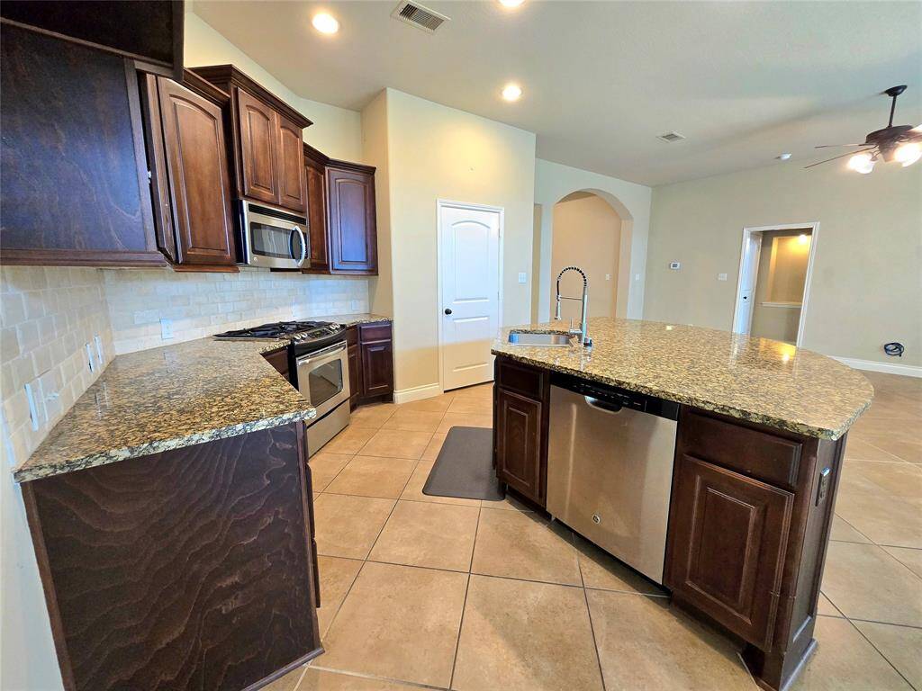 Recessed Lit Kitchen and Granite Countertops that flows into the living room. Great for Entertaining!