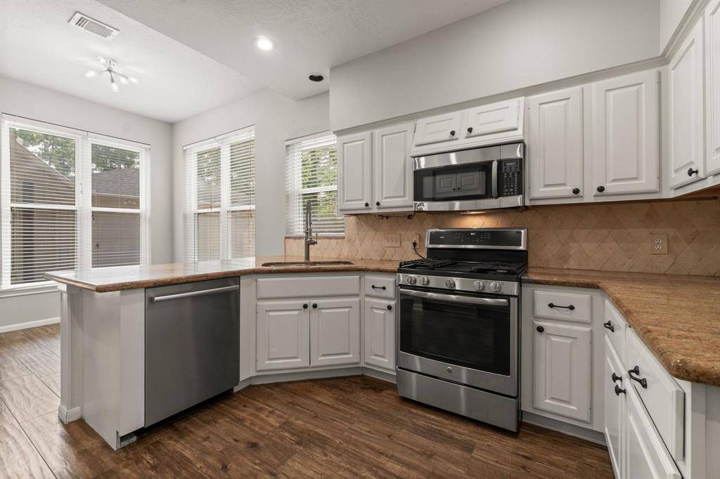 This kitchen features generous counter space, a bar-height counter perfect for chatting with guests while you cook, and a spacious layout ideal for entertaining.