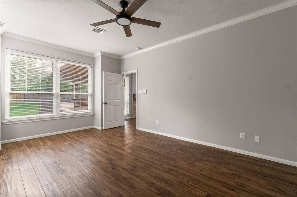 This primary bedroom offers easy access to the main living area and to the en-suite primary bath.