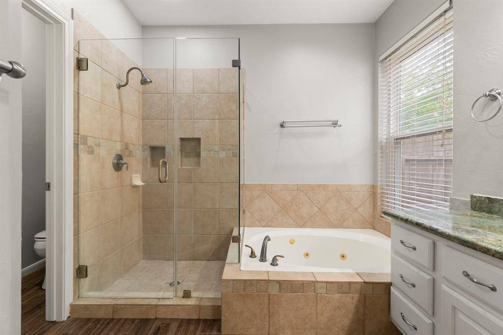 The primary en-suite features a separate shower and a soaking tub for added comfort and relaxation.