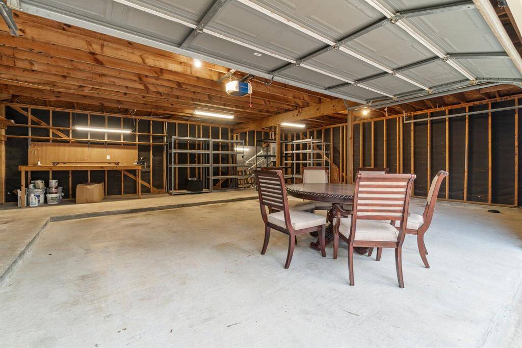Make the most of the spacious three-car garage, equipped with movable shelving and a workbench—perfect for storage, projects, and more.