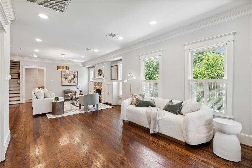 Secondary living area; note custom window treatments throughout—wood slat blinds and light-filtering roller shades.