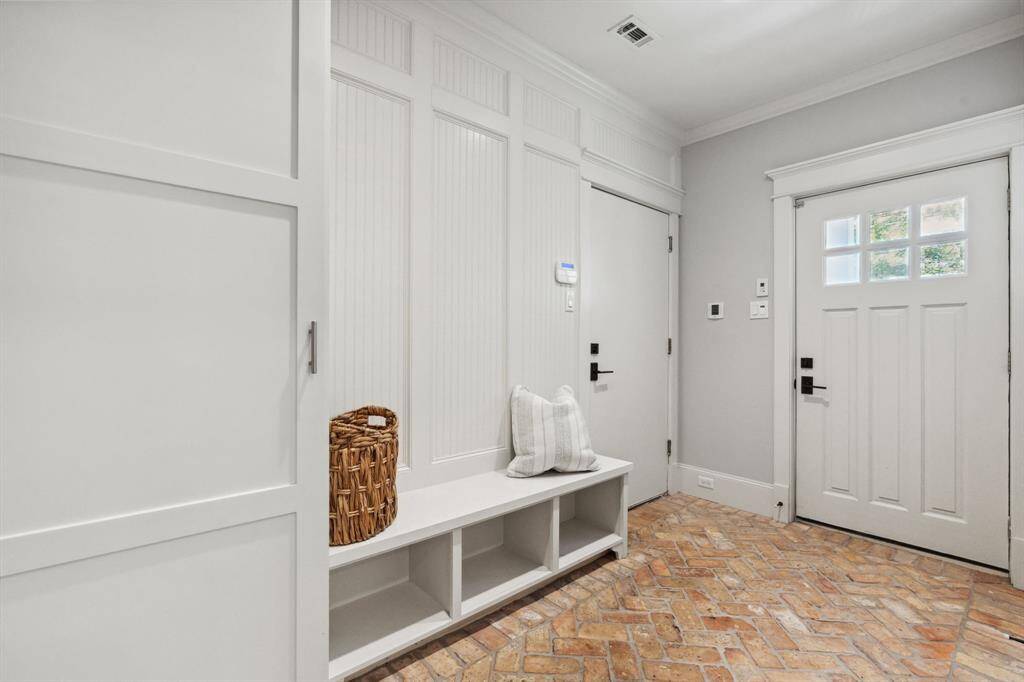 Custom drop zone with herringbone brick floors—form meets function.