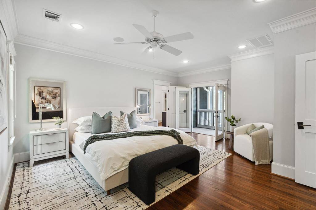 Retreat-worthy primary with French doors opening to a private balcony.