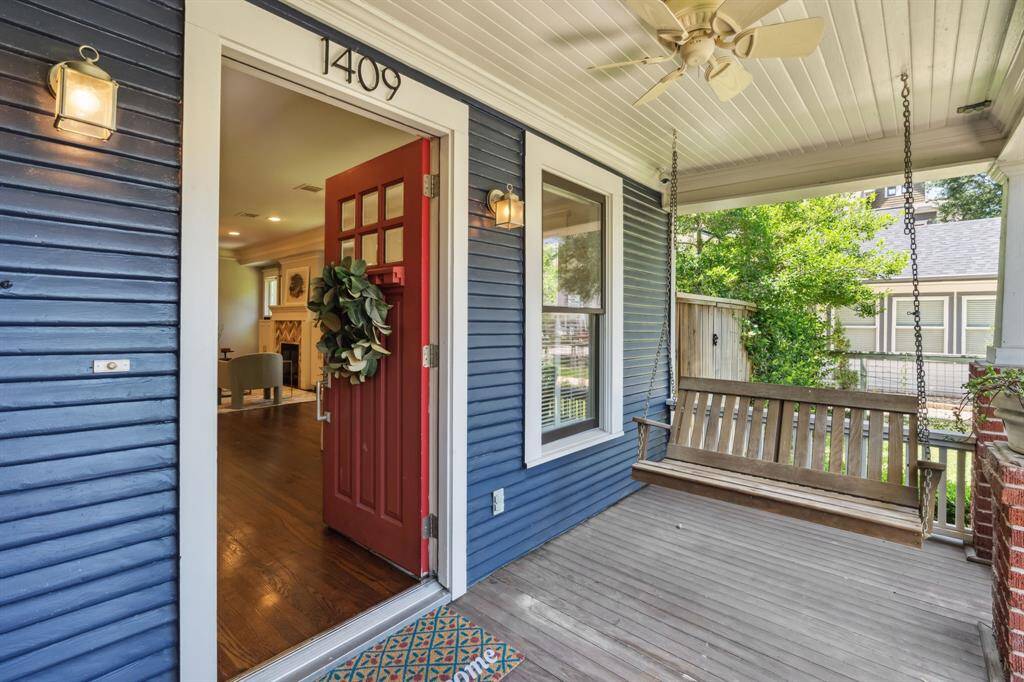 Charming front porch swing and ceiling fan to help with warmer days.