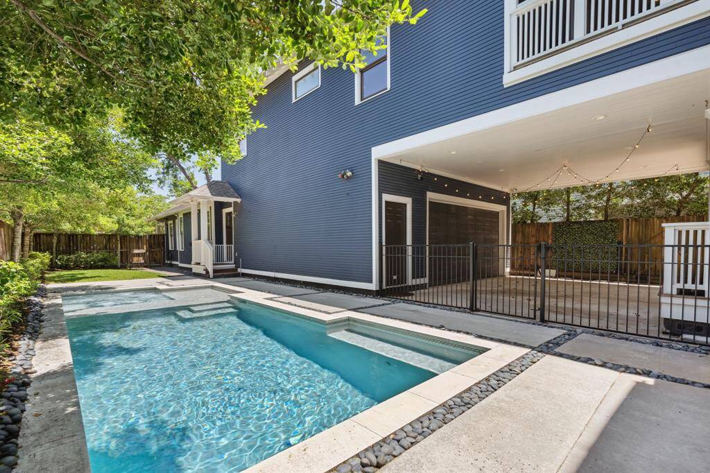 A sleek safety fence defines the pool area, while the built-in mosquito misting system keeps the space comfortable year-round.