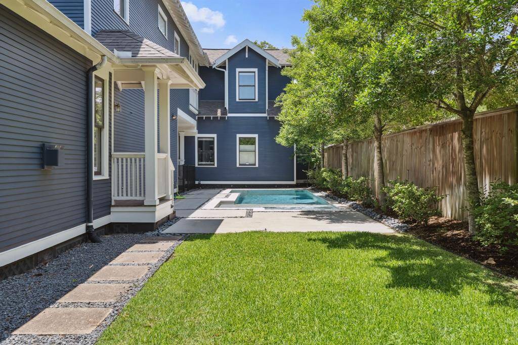 Thoughtfully landscaped with privacy in mind—lush greenery and mature trees line the entire backyard perimeter.