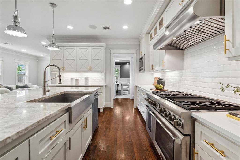 Thermador range, apron-front sink, and job-built cabinetry elevate everyday living.