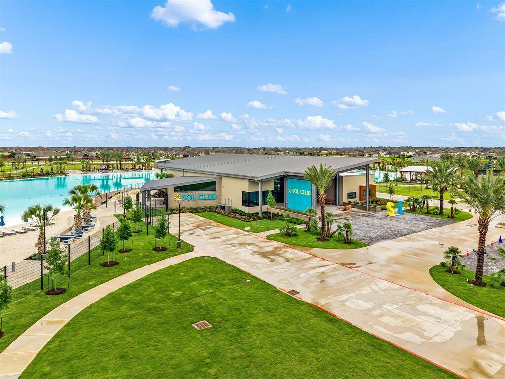 Surrounding the lagoon, the Sol Club Amenity Village features a clubhouse, boardwalk, event lawn, sports fields, pickleball courts, playgrounds, and walking trails, creating a vibrant hub for relaxation and recreation.
