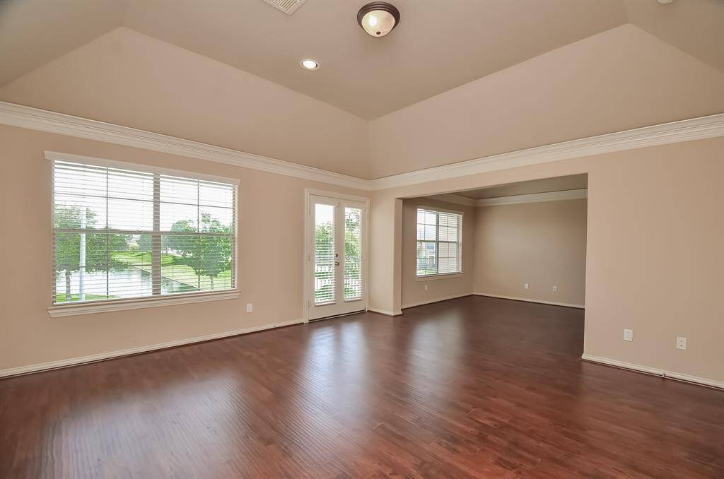 Spacious master bedroom with abundant natural light, featuring a cozy study and a private balcony.