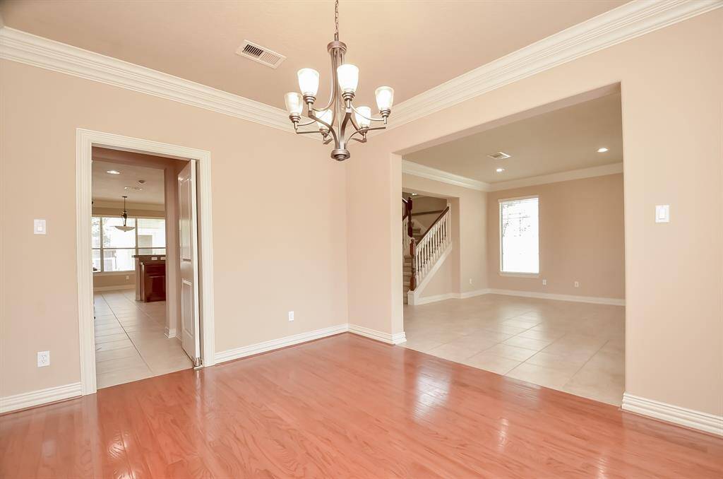 Elegant dining room featuring beautiful wood flooring.