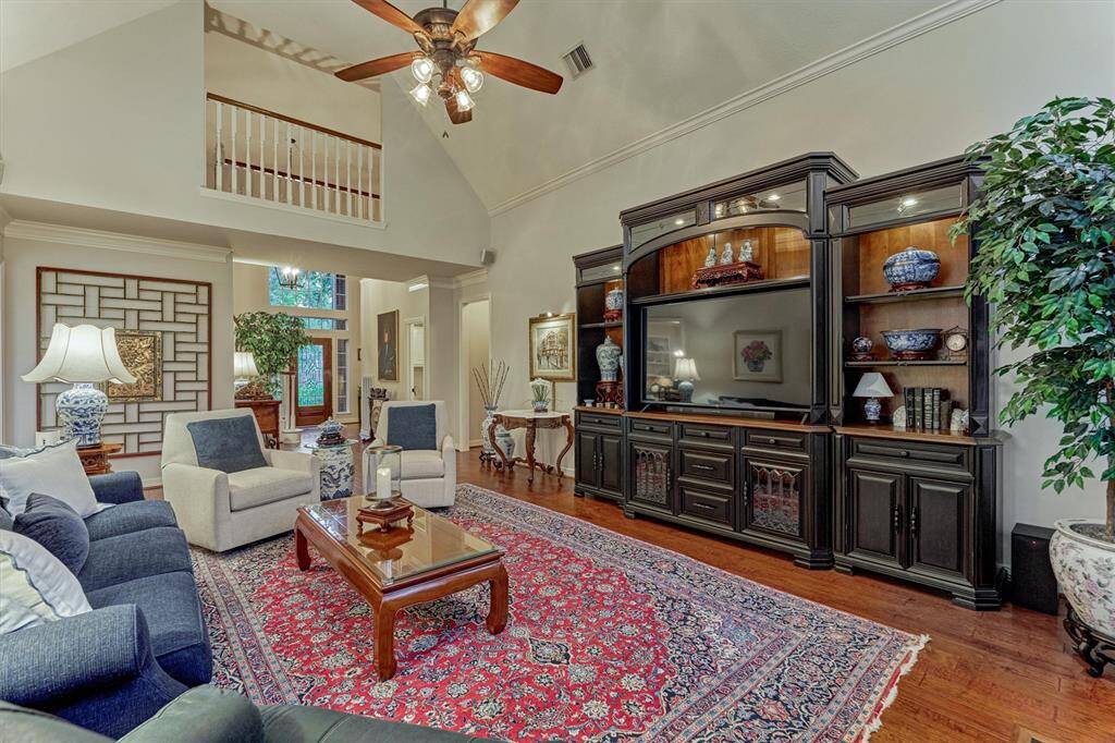 This photo showcases a spacious living room with high ceilings and a warm, inviting atmosphere.
