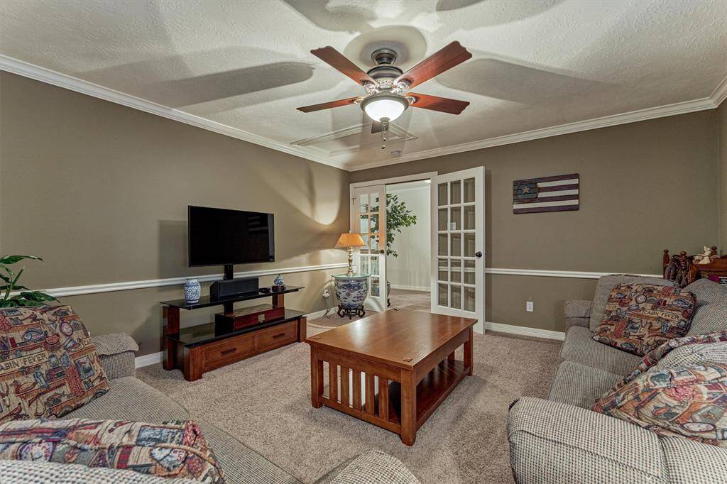 Large cozy gameroom enclosed with french doors.