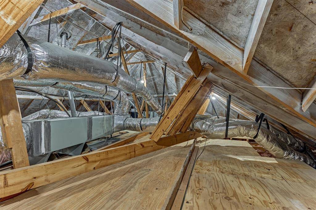 Floored attic space perfect for storage and maintenance work.