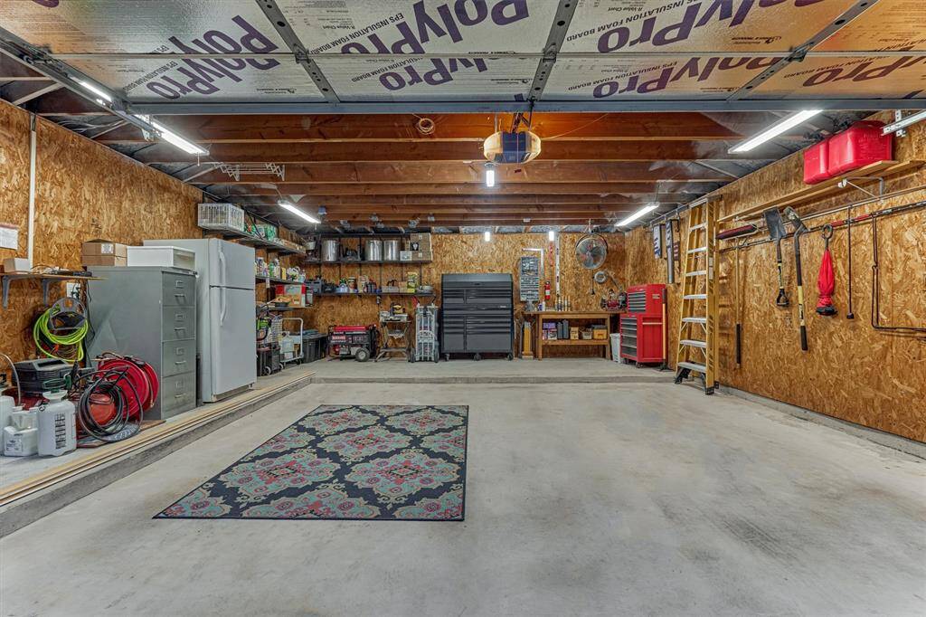 Spacious and organized garage with ample storage space.  Features include a refrigerator, and extra garage extension ideal for DIY projects or extra storage space.
