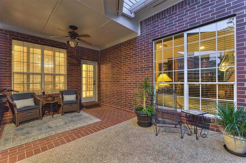 This inviting covered patio is enclosed with elegant fencing to protect children and pets from the pool area.
