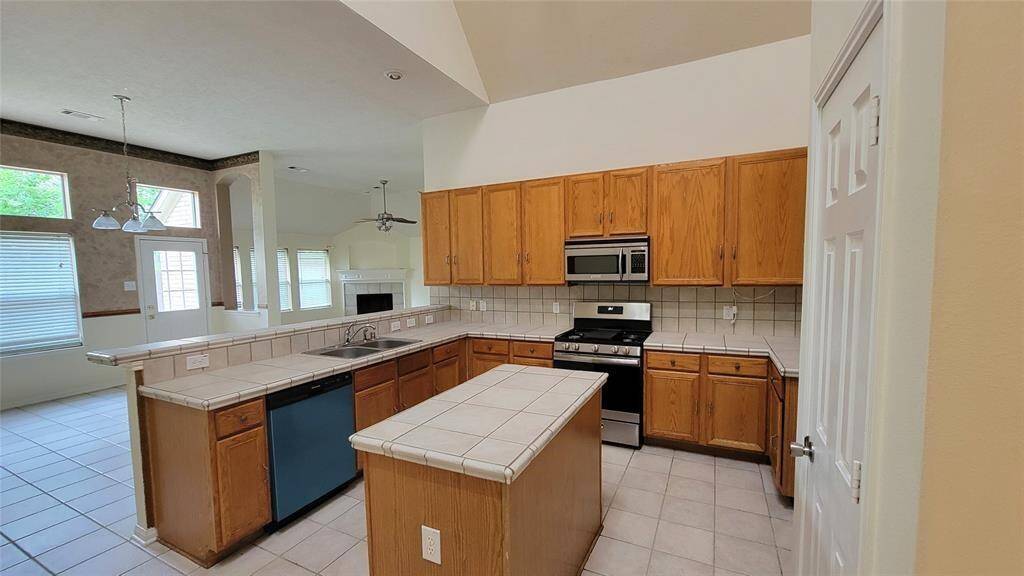 Spacious and private, the primary bedroom features soft carpeting, a ceiling fan, and generous closet space. It provides a peaceful retreat after a long day.
