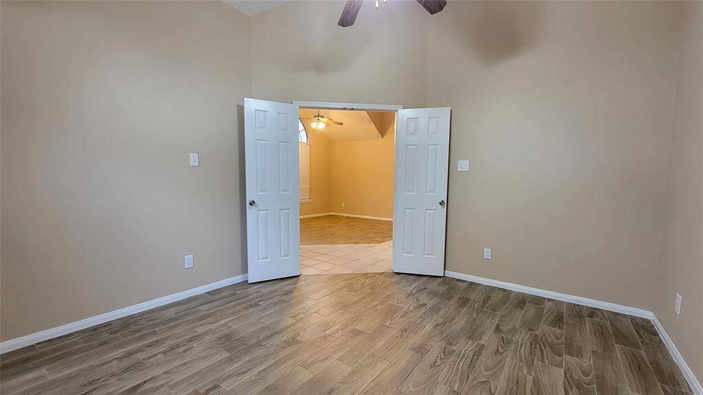 Spacious and private, the primary bedroom features soft carpeting, a ceiling fan, and generous closet space. It provides a peaceful retreat after a long day.