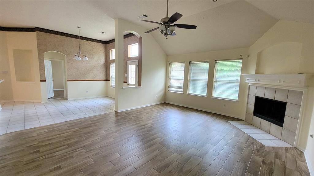 Bright and airy living space featuring neutral tones, tile flooring, and large windows that let in natural light. A cozy layout ideal for family gatherings or quiet evenings.