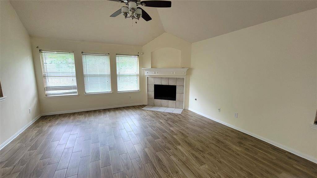 Bright and airy living space featuring neutral tones, tile flooring, and large windows that let in natural light. A cozy layout ideal for family gatherings or quiet evenings.
