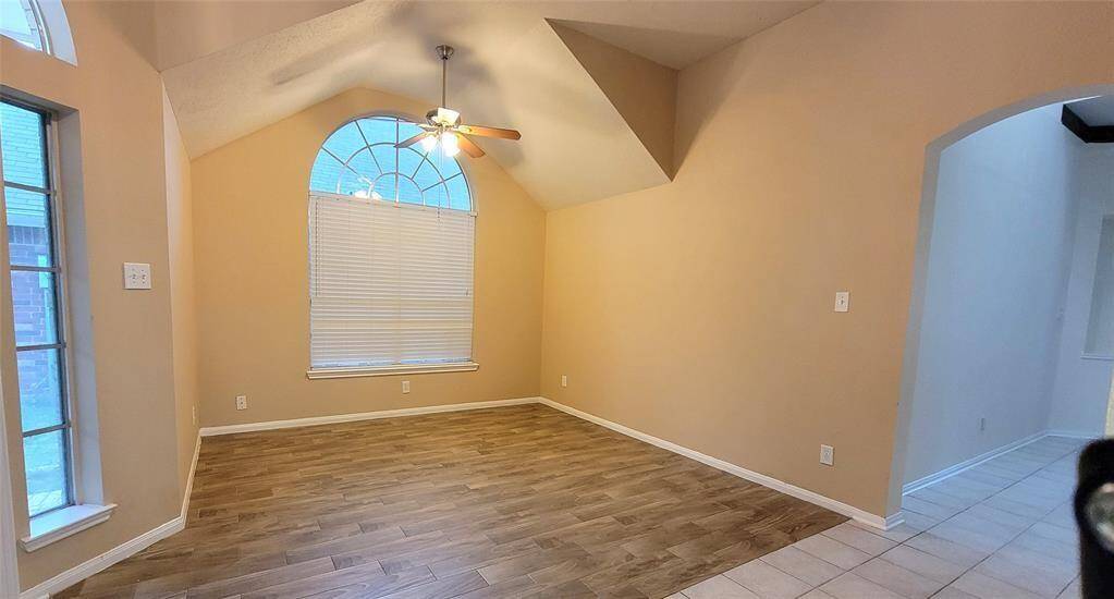 Bright and airy living space featuring neutral tones, tile flooring, and large windows that let in natural light. A cozy layout ideal for family gatherings or quiet evenings.