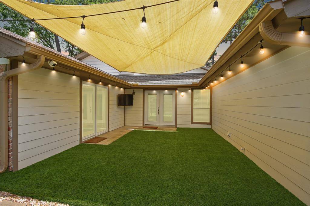 Charming private courtyard with turf and ambient string lighting—ideal for evening gatherings or quiet mornings. Enjoy effortless indoor-outdoor living with direct access to both the living room and master suite.