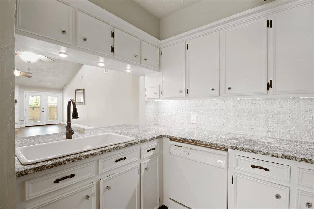 This kitchen lets you stay connected with family, friends, and guests while preparing meals, offering a seamless view into the spacious living room—perfect for hosting and making memories.