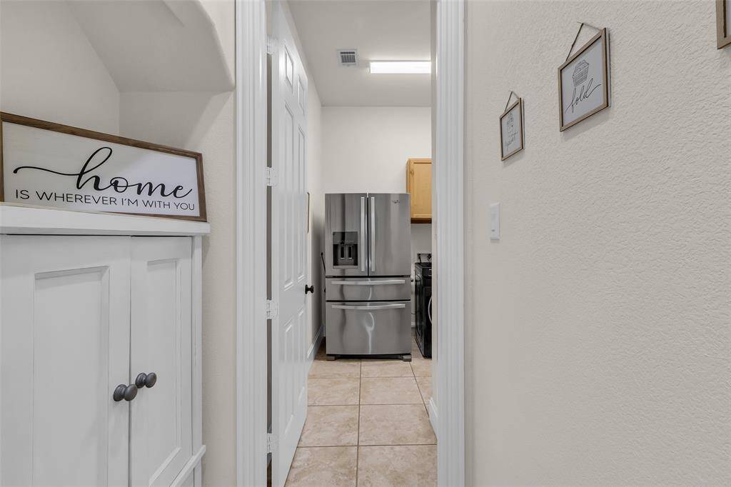 Tucked away utility room with fridge