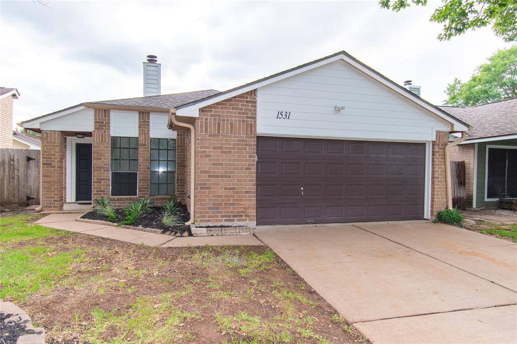 The entrance is accentuated by large windows, offering plenty of natural light.