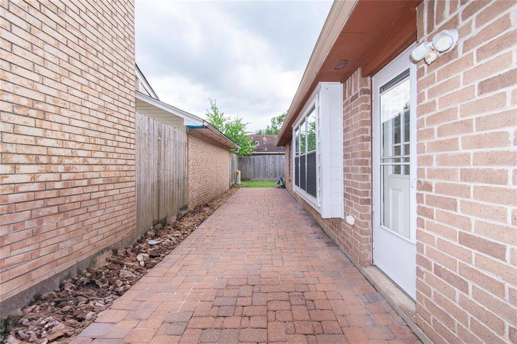 There's a side door with windows on the right, providing access to the house.
