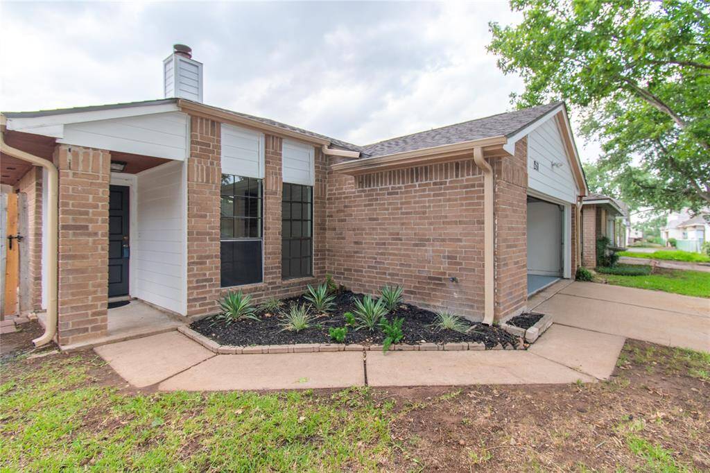 Charming and well-maintained landscaping enhances the home's curb appeal, featuring neatly arranged plants and a welcoming walkway.