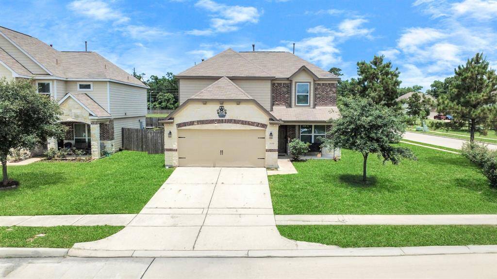 Stunning corner-lot curb appeal with spacious front yard and mature landscaping.
