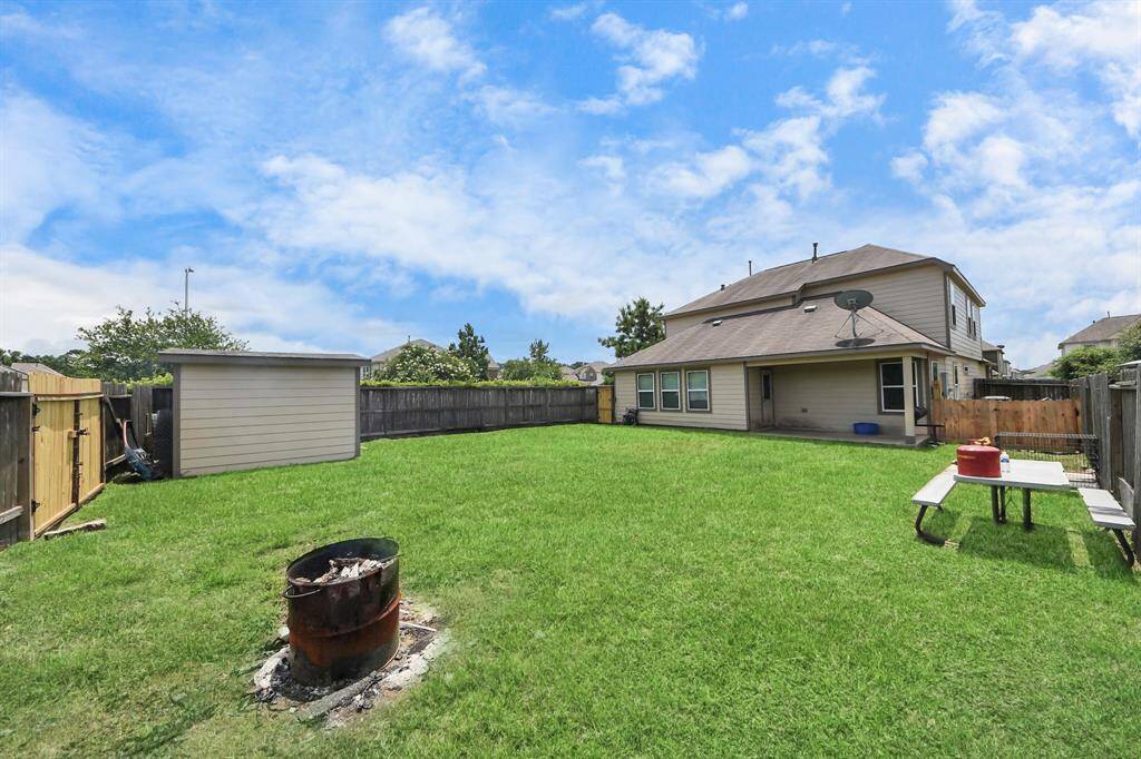 Large fenced backyard with patio space — great for relaxing or hosting.