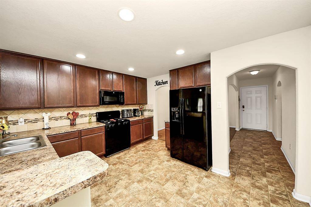 Modern kitchen with ample counter space, updated appliances, and breakfast bar.
