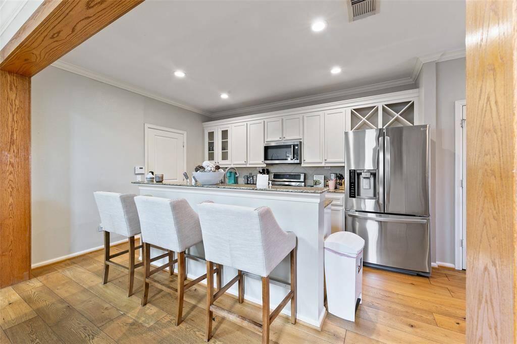 Wine racks above the fridge and ample kitchen storage space.