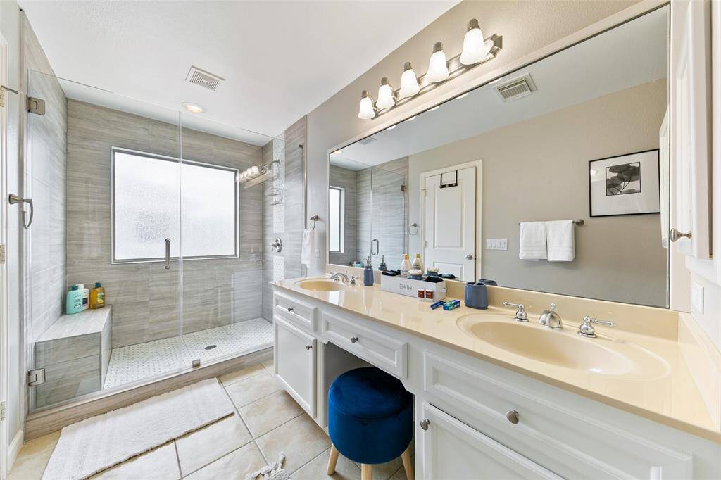 Primary bathroom features frameless glass walk in shower. Walk in closet is HUGE.
