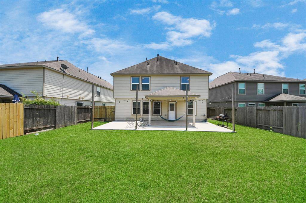 Oversized covered patio with large fenced backyard for entertaining friends and family.
