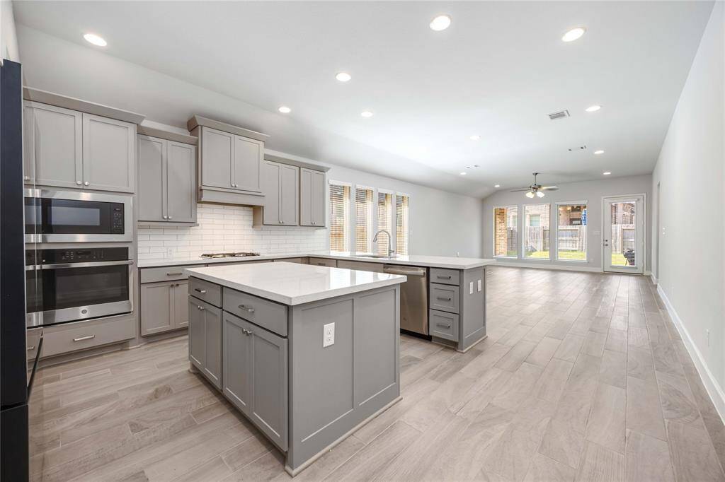 Kitchen with center island and wrapped bar